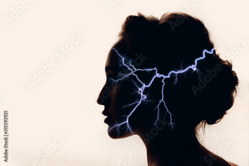 Fotografie, Obraz Silhouette of woman with lightning in head. Medicine concept.