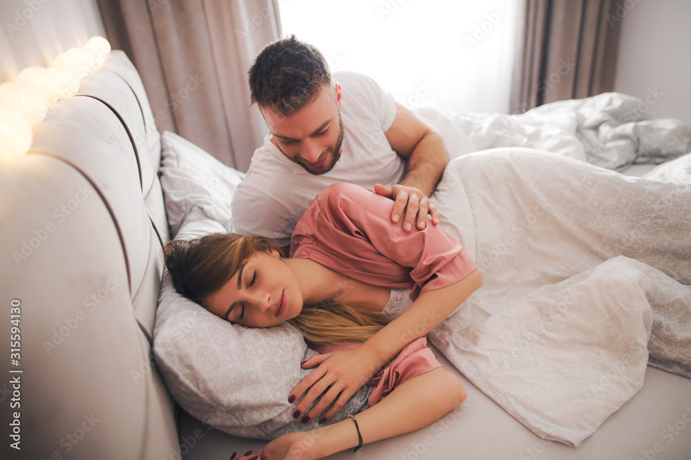 Man trying to wake up his girlfriend. Man trying to wake up his girlfriend.