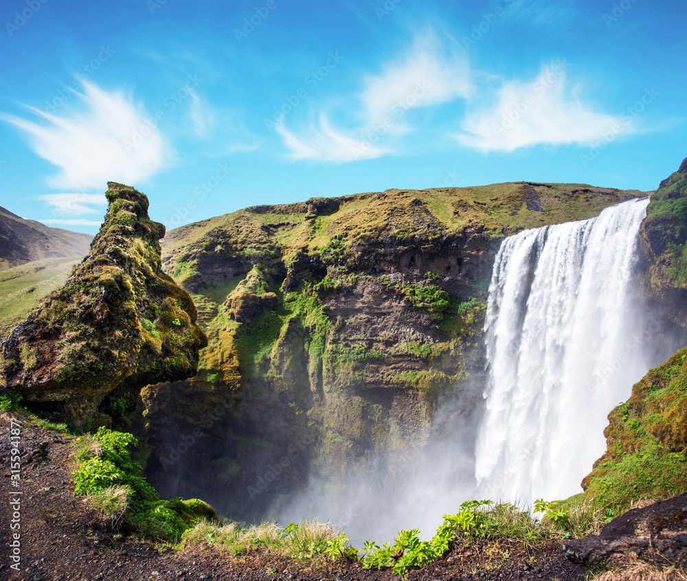Magical landscape with silhouette of human head in front of waterfall Skogafoss in Iceland. Exotic countries. Amazing places. Popular tourist atraction.