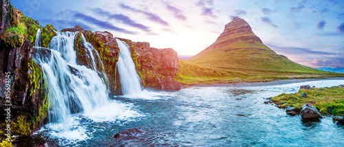 Beautiful magical scenery with a waterfall Kirkjufell near the volcano in Iceland at sunset. Exotic countries. Amazing places. Popular tourist atraction. (Meditation, antistress - concept).