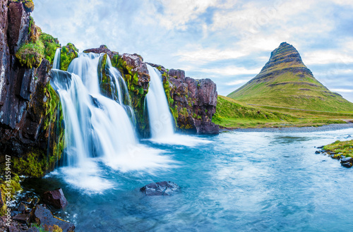 Beautiful natural magical scenery with a waterfall Kirkjufell near the volcano in Iceland. Exotic countries. Amazing places. Popular tourist atraction. (Meditation, antistress - concept).