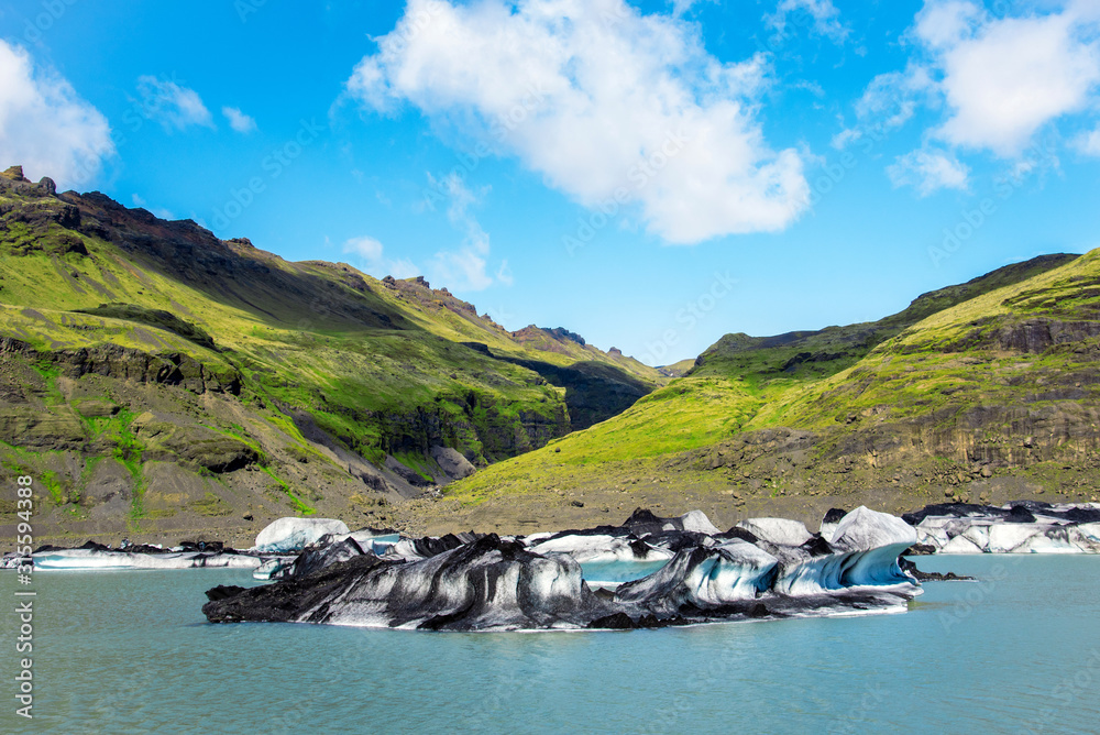Breathtaking scenery with nice ice block in Solheimajokull lagune, Iceland. Exotic countries. Amazing places. Popular tourist atraction. (global warming – concept)