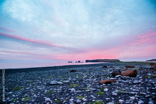 majestic view from the black sand beach on Reynisdrangar Sea Cliffs at dawn on cape Dyrholaey near Vik, Iceland. Exotic countries. Amazing places.