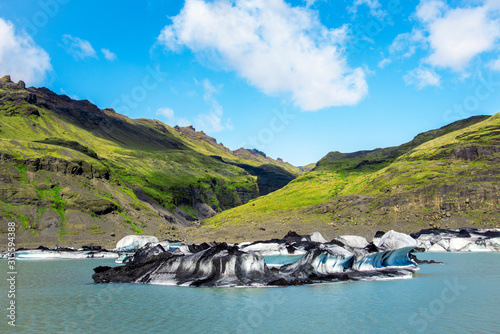 Obraz na płótnie Breathtaking scenery with nice ice block in Solheimajokull lagune, Iceland. Exotic countries. Amazing places. Popular tourist atraction. (global warming – concept) w salonie
