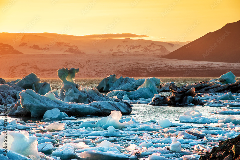 Magical beautiful landscape with ice depths in the famous Jokulsarlon glacial lagoon in Iceland at sunset. Exotic countries. Amazing places. Popular tourist atraction. (global warming – concept)