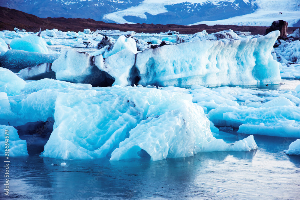 Magical beautiful landscape with ice depths in the famous Jokulsarlon glacial lagoon in Iceland. Exotic countries. Amazing places. Popular tourist atraction. (global warming – concept)