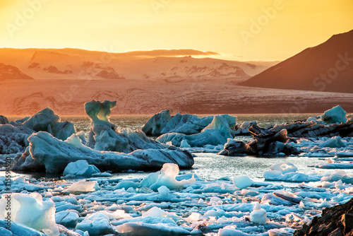 Obraz na płótnie Magical beautiful landscape with ice depths in the famous Jokulsarlon glacial lagoon in Iceland at sunset. Exotic countries. Amazing places. Popular tourist atraction. (global warming – concept) w salonie