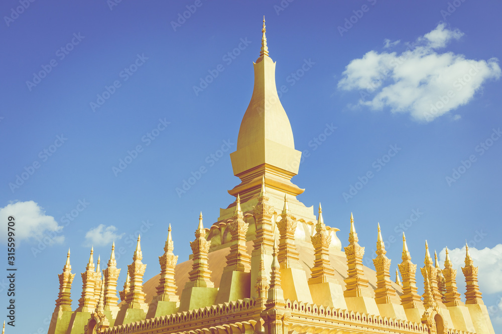 Naklejka premium Pha That Luang temple - The Golden Pagoda in Vientiane , Laos