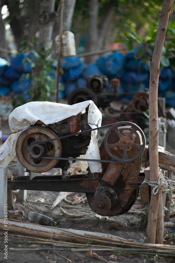 Old engine of fishing boat scrap on the beach