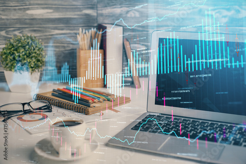 Financial graph colorful drawing and table with computer on background. Multi exposure. Concept of international markets. © peshkova