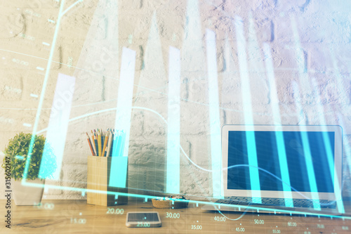 Forex market graph hologram and personal computer on background. Double exposure. Concept of investment. © peshkova