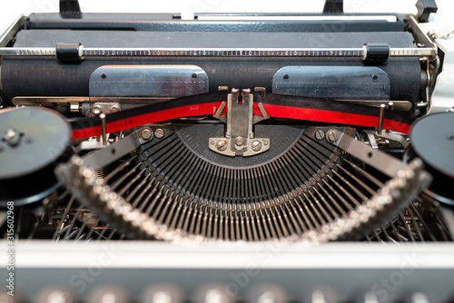 Classic, manual typewriter in white with a German keyboard layout, isolated on a white background with a clipping path.