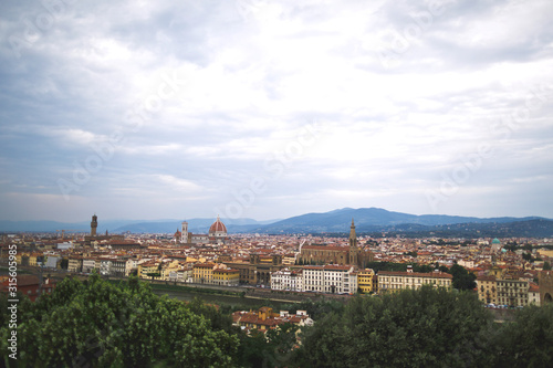 Beautiful bird's-eye view of Florence and the Arno river. Cloudy sky. Travel background.