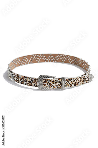 Subject shot of a white belt with leopard print and decorated with solid buckle and a great number of rhinestones. The stylish belt is isolated on the white background.