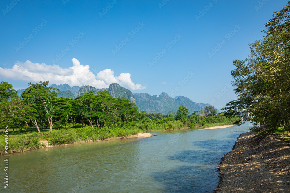 Village and mountain in Vang Vieng, Laos and Nam Song rive , Laos. Southeast Asia. Village and mountain in Vang Vieng, Laos and Nam Song rive , Laos. Southeast Asia.