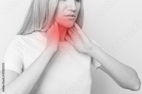 Photo Female checking thyroid gland by herself
