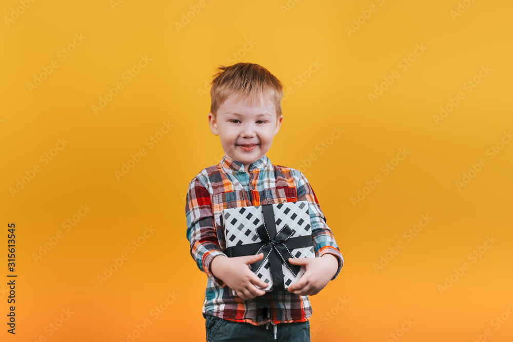 Little boy in shirt holding present for girl or mother, Valentines day, mother's day, Happy surprised and cute child hugging his gift. Little boy in shirt holding present for girl or mother, Valentines day, mother's day, Happy surprised and cute child hugging his gift.