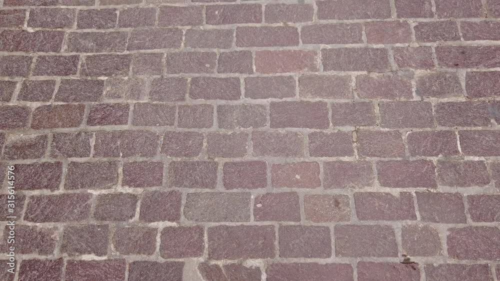Walking along the cobblestone sidewalk street. Point of view. Walking along the cobblestone sidewalk street. Point of view.