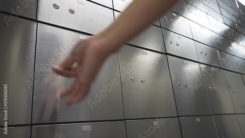 Hand close Metal safe box panel wall. Concept for security and banking protection.