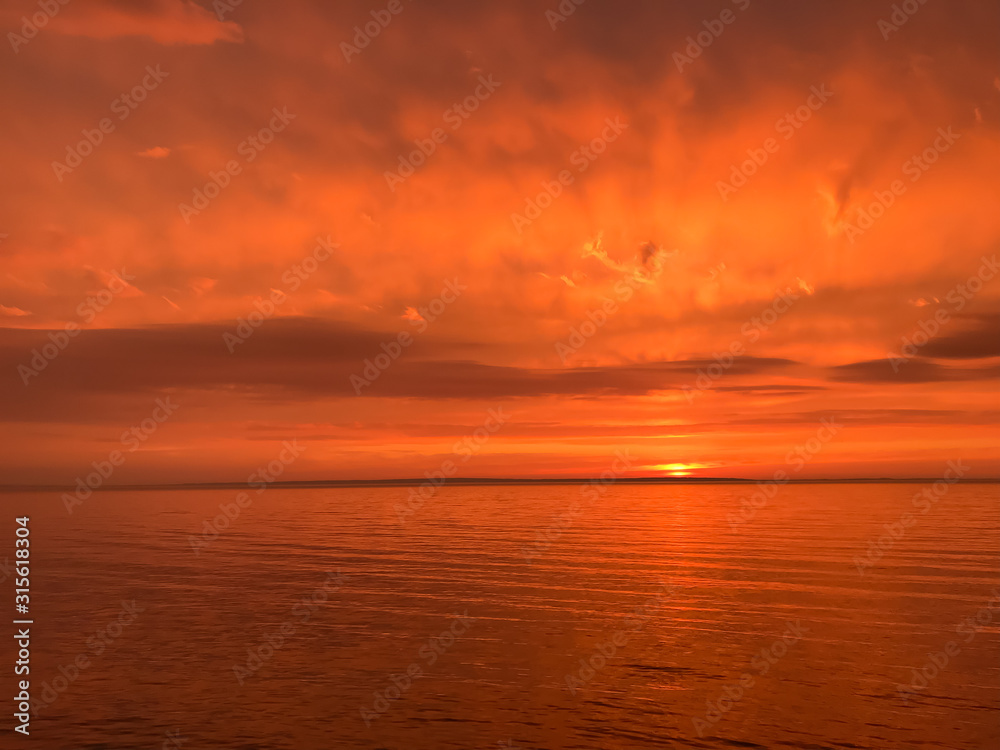 Red orange fire sunset at the sea
