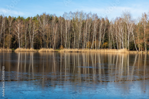 Fototapeta Naklejka Na Ścianę i Meble -  Frozen winter lake and forest in Poland.