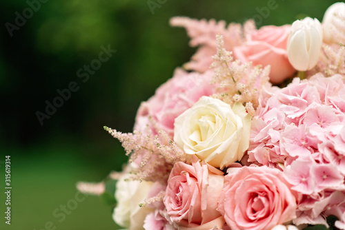 Close-up of a wedding bouquet on a green background. Copy space.