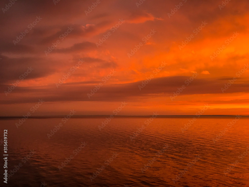 Red orange fire sunset at the sea