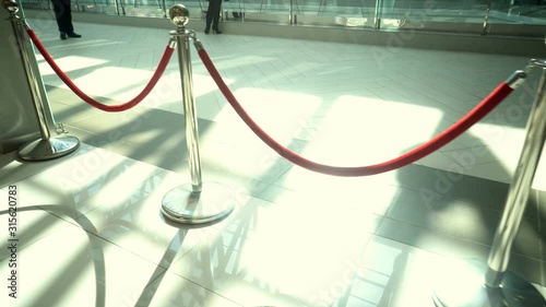 Silver metal stanchions with red velvet rope for VIP access