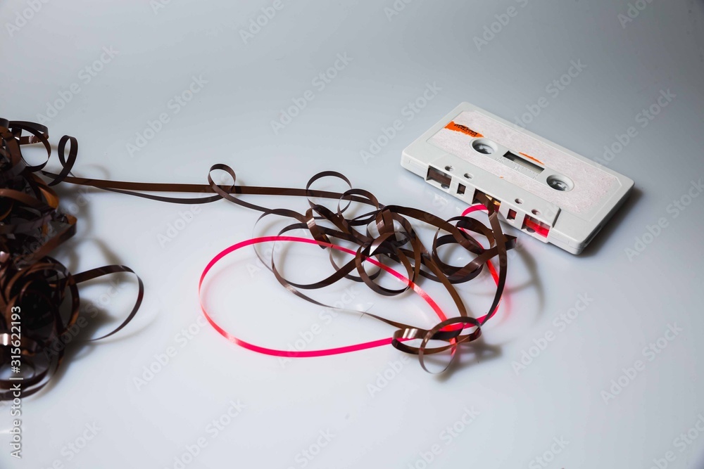 Leeds, UK, 03/02/19Cassette unspooled with loose tape tangled up around itself shot on isolated on a white background professionally with studio lighting and old retro vintage media unused now Leeds, UK, 03/02/19Cassette unspooled with loose tape tangled up around itself shot on isolated on a white background professionally with studio lighting and old retro vintage media unused now