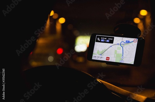 Φωτογραφία Leeds, UK, 01/03/19 Over the shoulder shot of a man driving a car with one hand