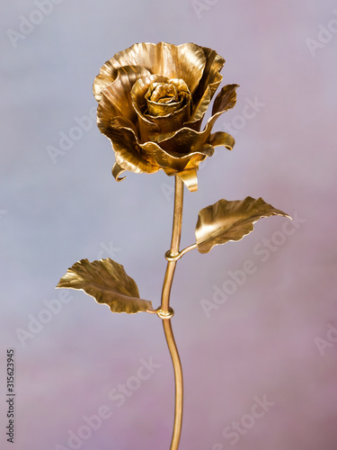  golden rose made of metal as symbol of eternal love
