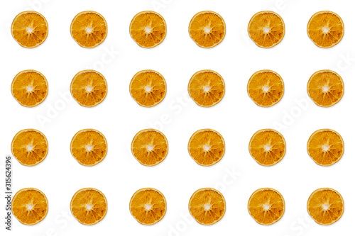 Pattern of dried orange slices on a white background. Isolated. Copy space.