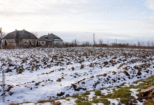 Winter ploughed field under blue sky