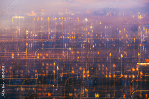 many glowing windows of the night city buildings. Motion blur long exposure light trails abstract composition