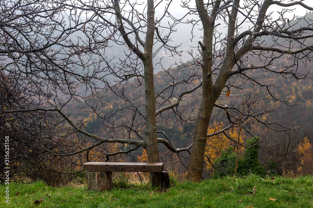 Fog in the mountains and bench in the foreground (Greece, Peloponnese).