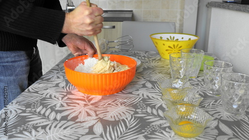 Фотография knead the cake with a wooden spoon