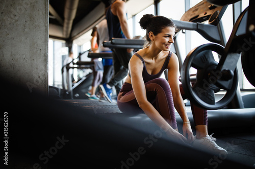 Close up image of attractive fit woman in gym