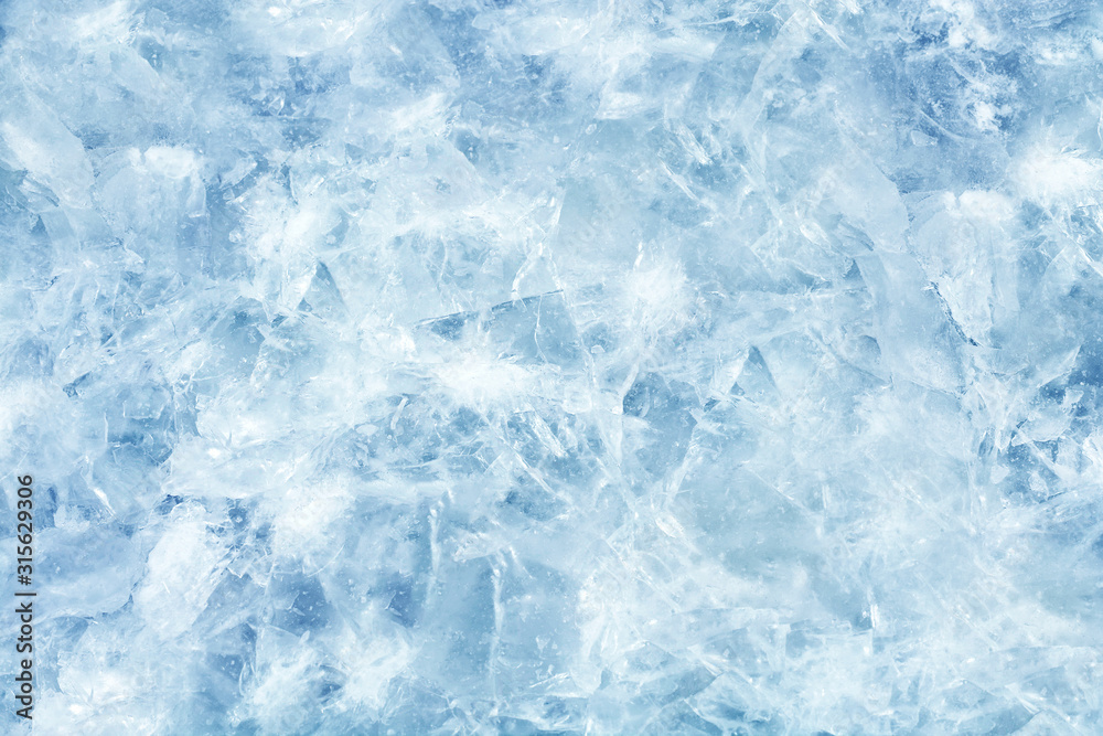 Cracked light blue ice. Frozen water in winter