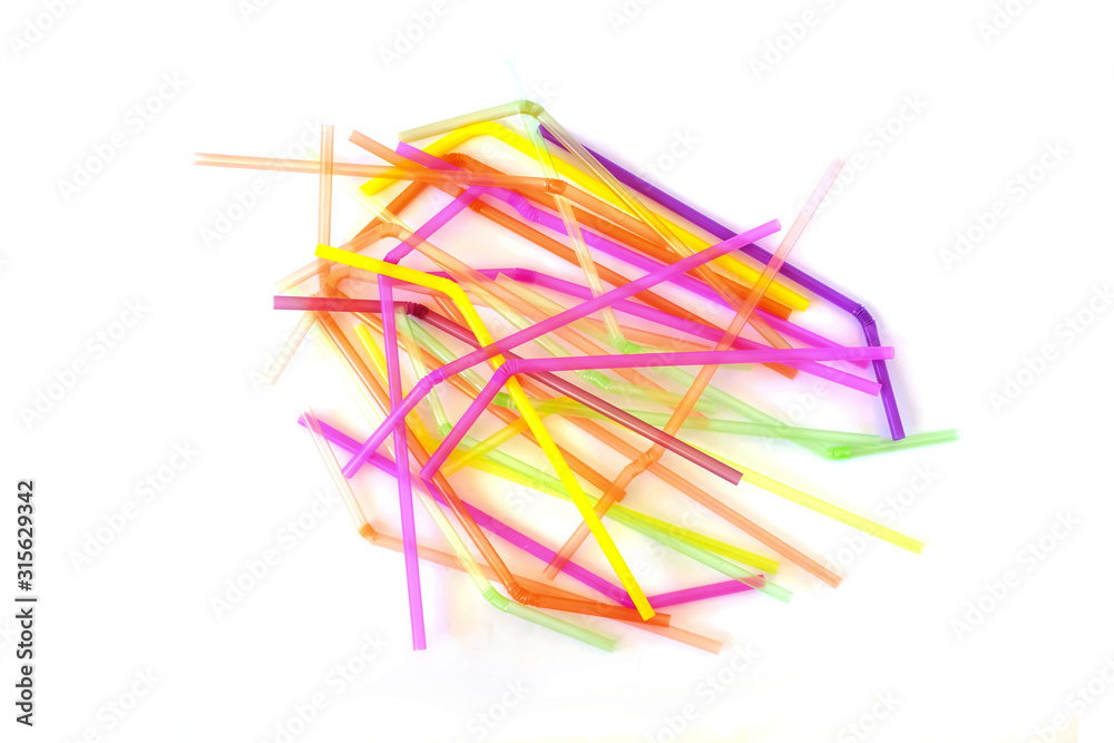 Fototapeta premium Colorful plastic drinking straws isolated on a white background. Top view.