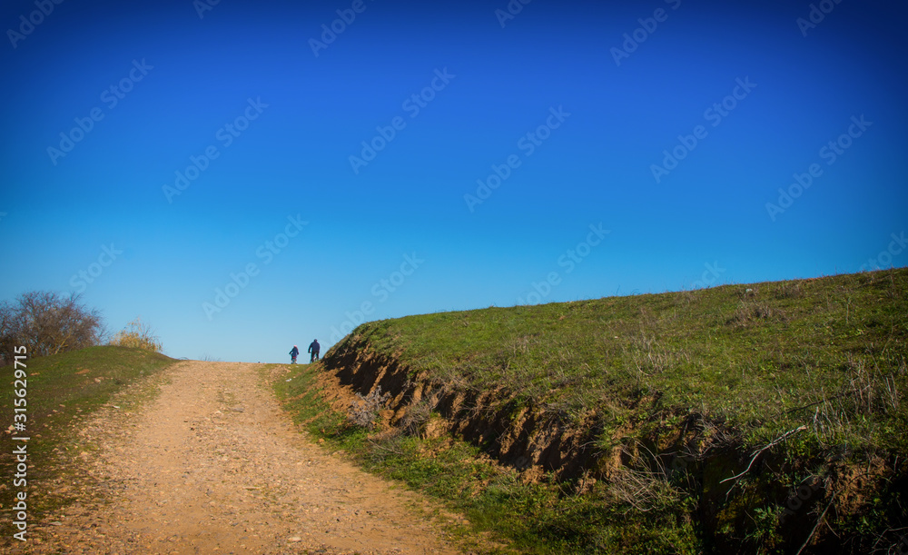 Fototapeta premium People walking through the countryside. Trekking.