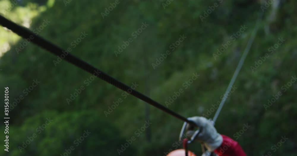 Young Caucasian man zip lining