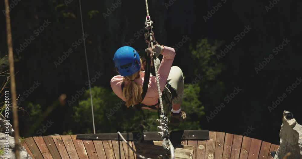 Young Caucasian woman zip lining