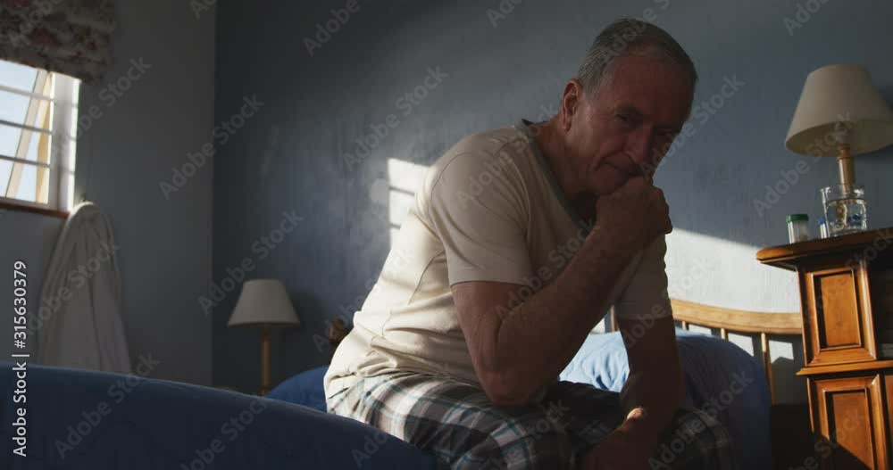 Senior man lying on bed at home Senior man lying on bed at home