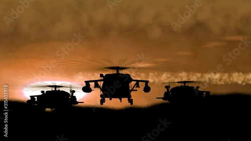 Three Silhouettes of military helicopters arise from a hill on a night orange sky sunset background. War concept.