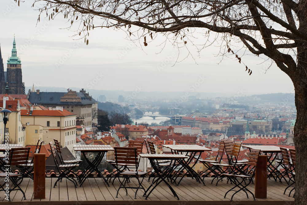 Panoramic view of Prague, the capital of the Czech Republic, and the Vltava river, traditional red rooftops from one of the Prague hills in late autumn