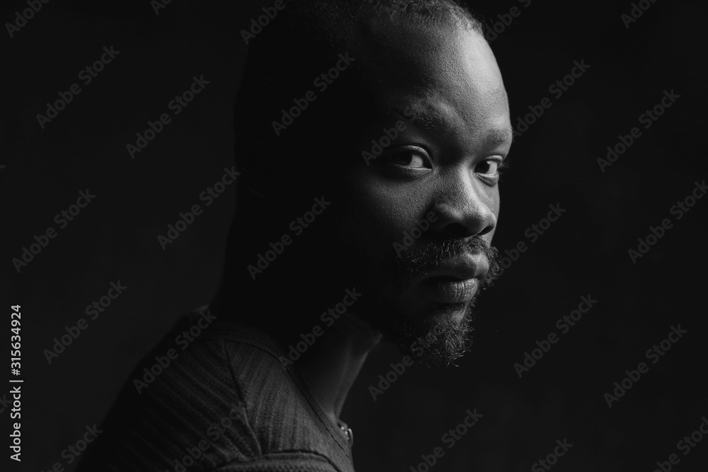 black and white portrait of a black handsome guy looking at the camera