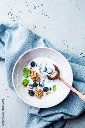 Healthy breakfast - yoghurt with blueberries and walnuts
