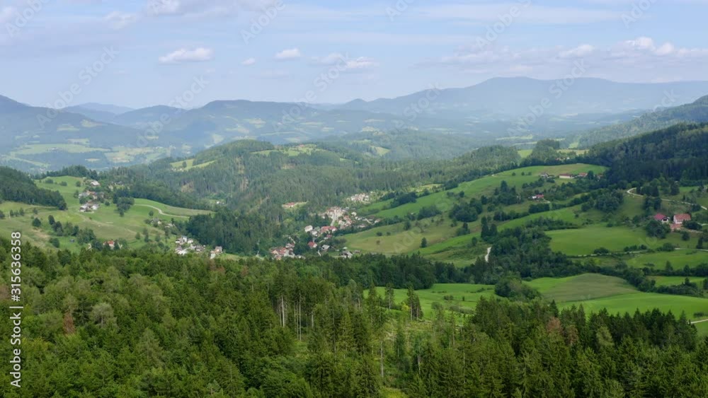 Aerial view above the forest with a view on Prevalje region villages and landscape in northern Slovenia Aerial view above the forest with a view on Prevalje region villages and landscape in northern Slovenia