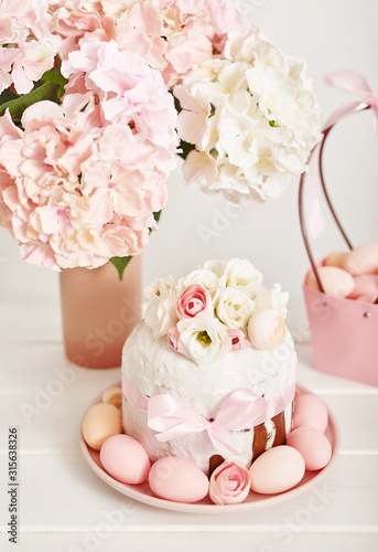 Easter orthodox sweet bread, kulich and colorful eggs with flowers. Holidays breakfast concept with copy space. Retro style. Easter greeting card template