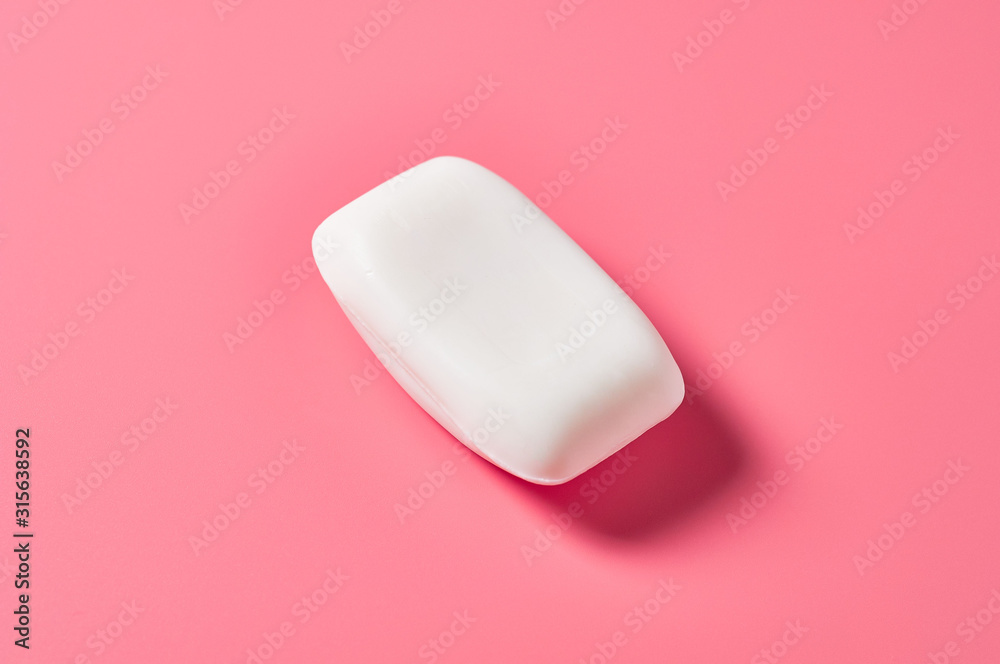 One whole antibacterial and anti allergic aromatic soap lies on pink countertop in bathroom or spa salon. Close-up One whole antibacterial and anti allergic aromatic soap lies on pink countertop in bathroom or spa salon. Close-up